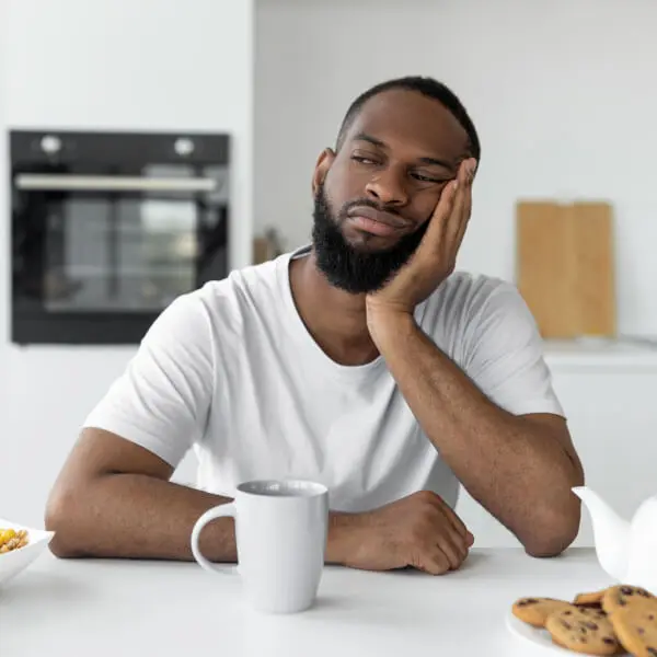 Un homme mal réveillé le matin, fatigué et déminéralisé.